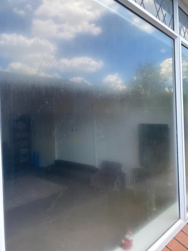 A conservatory window clouded with a permanent hazy film