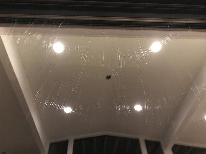 Glass covered in fine swirl scratches from grit dragged across it