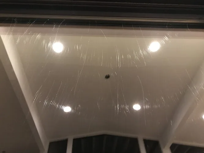 Glass covered in fine swirl scratches from grit dragged across it